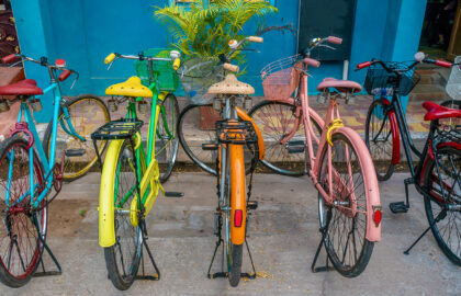 A,Row,Of,Vintage,Bicycles,Painted,Bright,Colors,,Parked,On